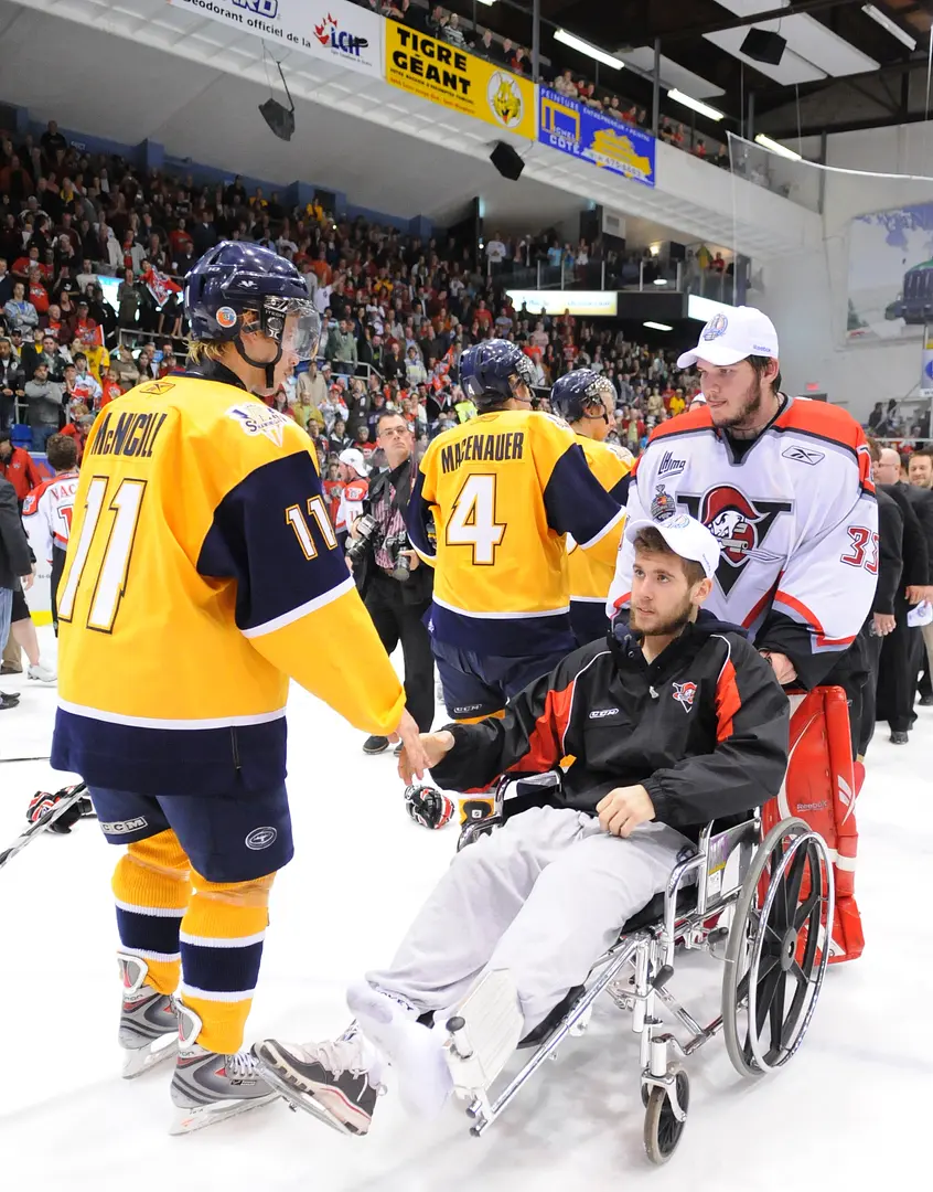Christopher DiDomenico missed part of the final because of a broken leg. Goaltender Marco Cousineau pushed his wheelchair for the post-final handshakes.
