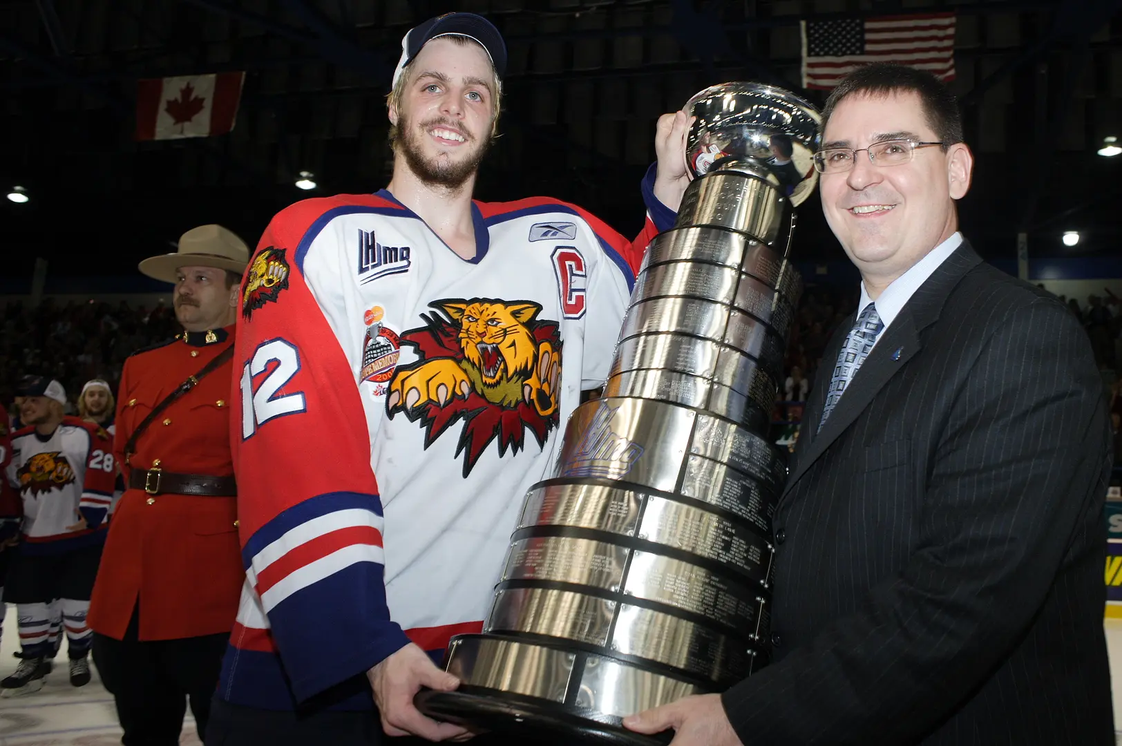 Captain Christian Gaudet receives the President Cup for the Wildcats at the end of the 2006 playoffs from QMJHL Commissioner Gilles Courteau.